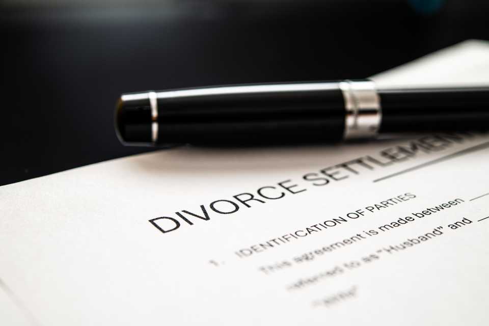 divorce agreement with pen to symbolize resolution