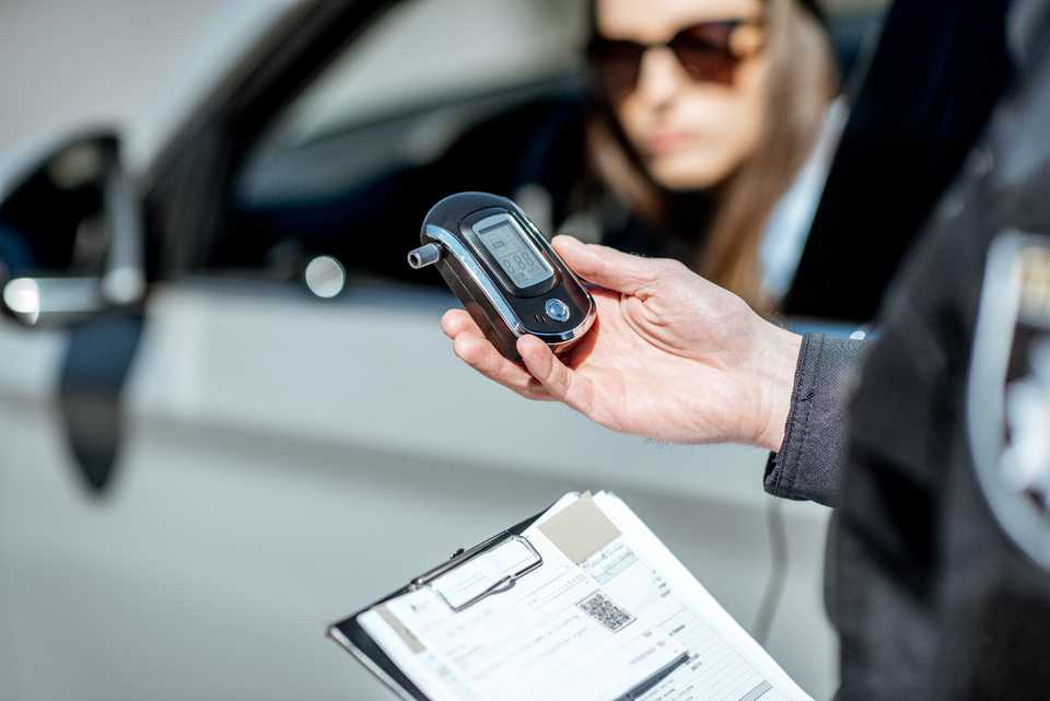 Police officer checking blood alcohol content