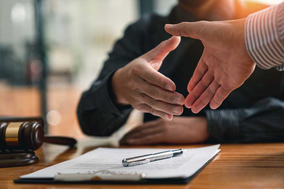 lawyer shaking hands with a client seeking citizenship in canada